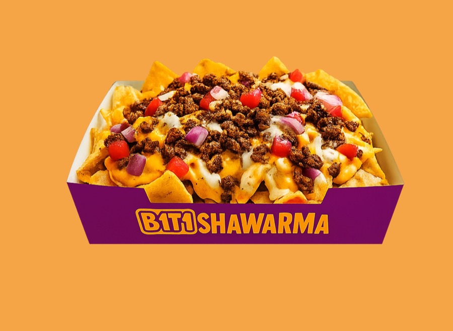 Beef nachos with cheese, tomato and onion